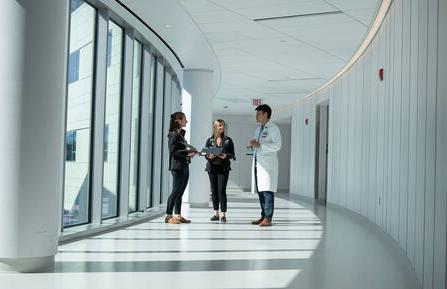 Cardiology colleagues talking in a hallway